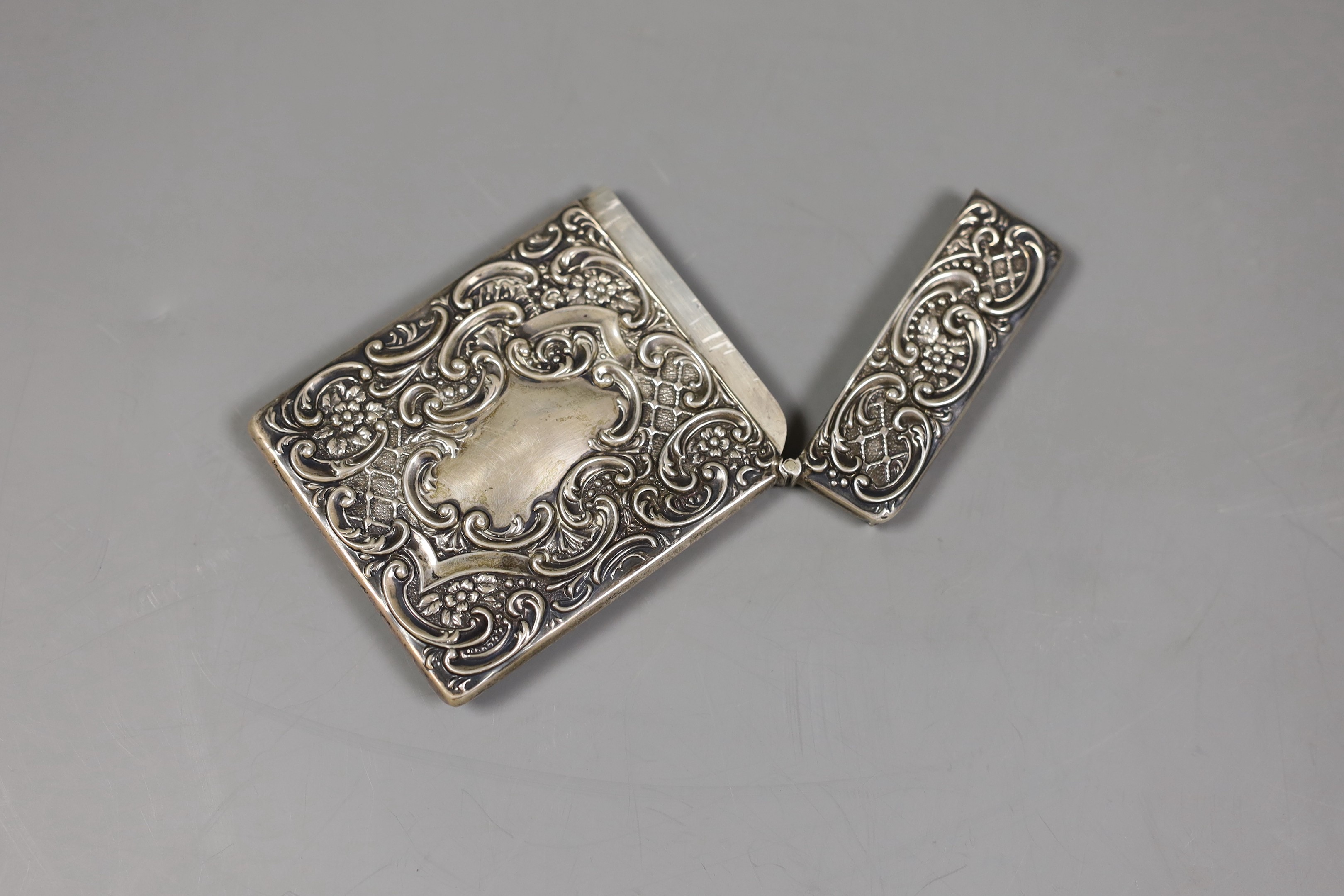 An Edwardian embossed silver card case, decorate d with stag in highland scene, Crisford & Norris, Birmingham 1903, 10.1cm.